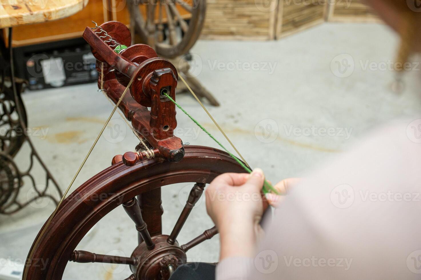 Distaff Day Female adult crafting with antique spinning wheel photo