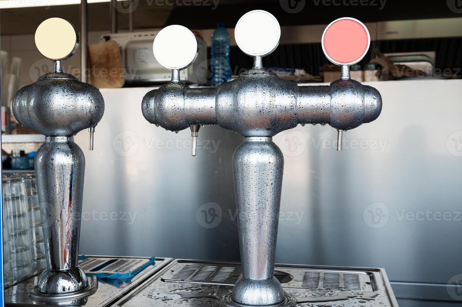 Bar tap dispensers with three different color handles in a refreshment facility photo