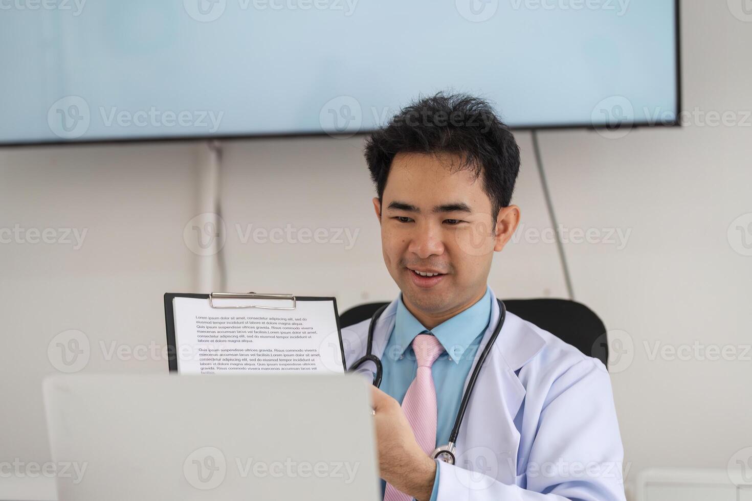 Telemedicine and Patient Consultation. A healthcare professional engaging in a virtual consultation while showing notes on a laptop. photo