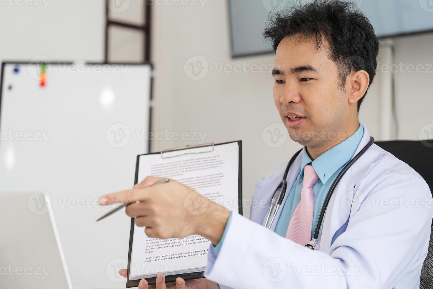 Patient Interaction in Healthcare. A doctor demonstrates health advice via consultation using a laptop. photo