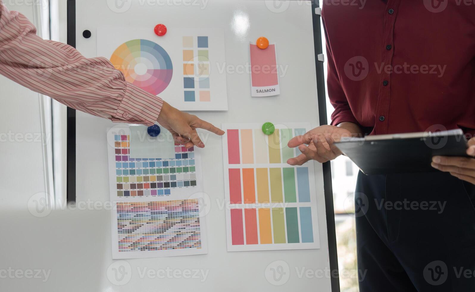 Color Selection and Collaboration. A creative team discussing color palettes for a design project. photo