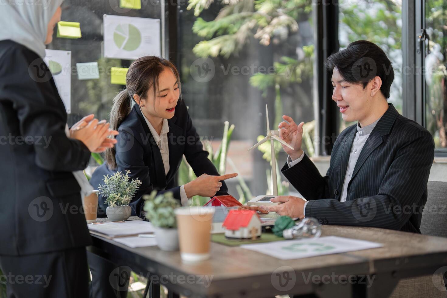 Sustainability and Business Ethics. A team discussing sustainable project proposals, showcasing collaboration and innovation in a modern workspace. photo