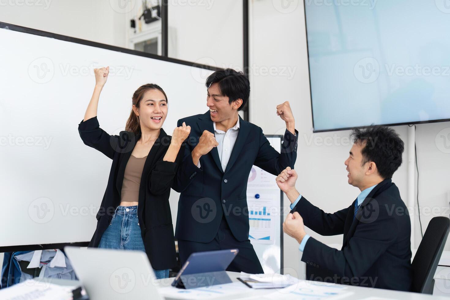 Victorious Teamwork and Enthusiasm. Colleagues celebrating their success and demonstrating team spirit. photo