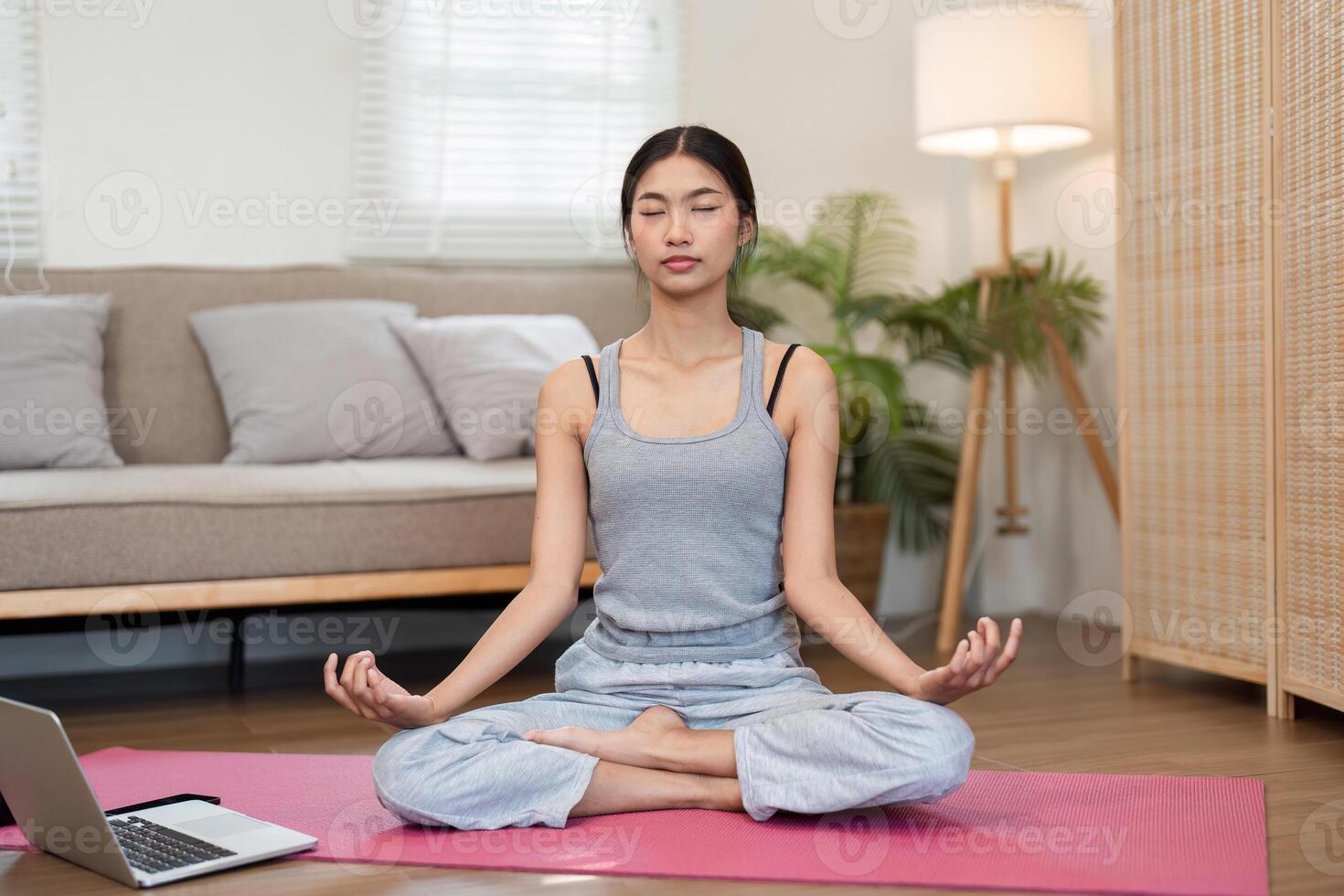 Yoga and Focus. A woman meditating with a serene expression for mindfulness at home. photo