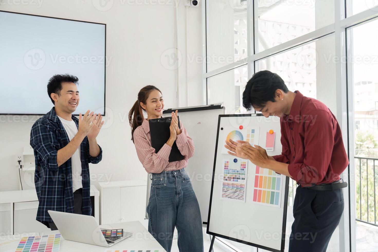 Presenting Ideas and Design Solutions. Team members showcase design concepts and gather feedback from each other in a creative workspace, enhancing collaboration and innovation. photo