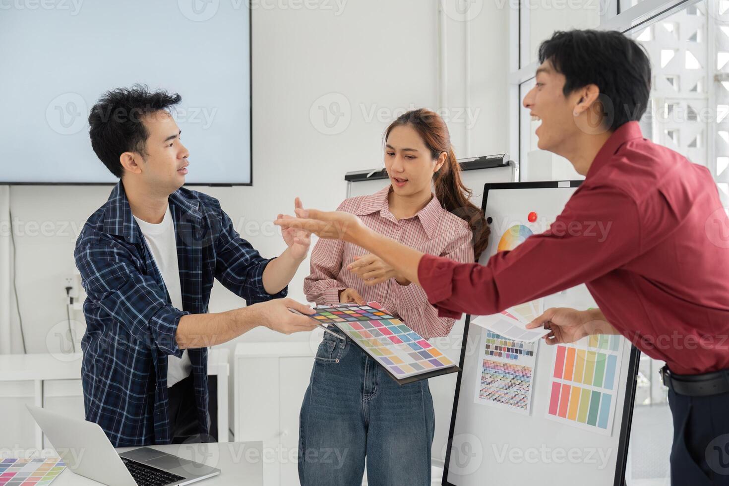 Dynamic Team Interaction on Color Selection. Team members sharing ideas and preferences on color palettes. photo