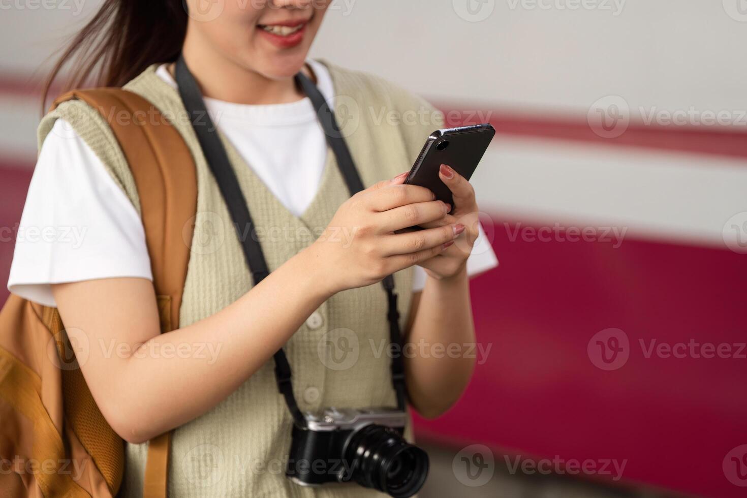 Technology and Travel. A young woman navigates her travel plans using her smartphone. photo
