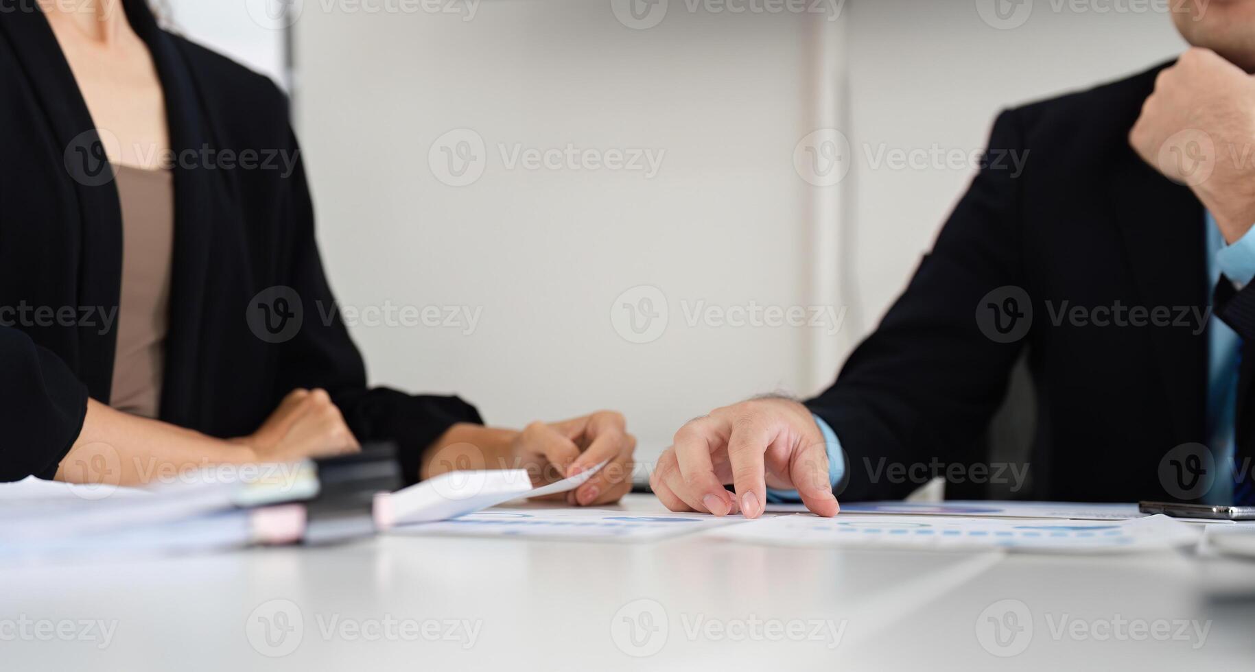 Focused Collaboration and Data Review. A close-up of a business discussion highlighting data analysis. photo