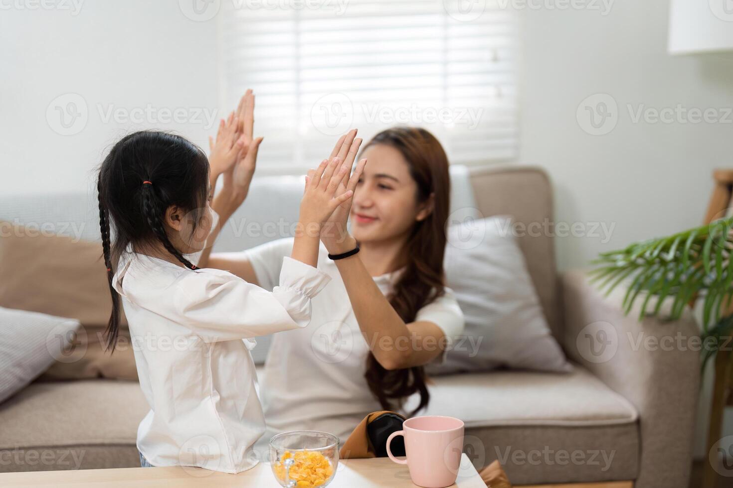 Fun and Learning Ahead A mother and daughter enjoy a playful moment as they prepare for school. photo