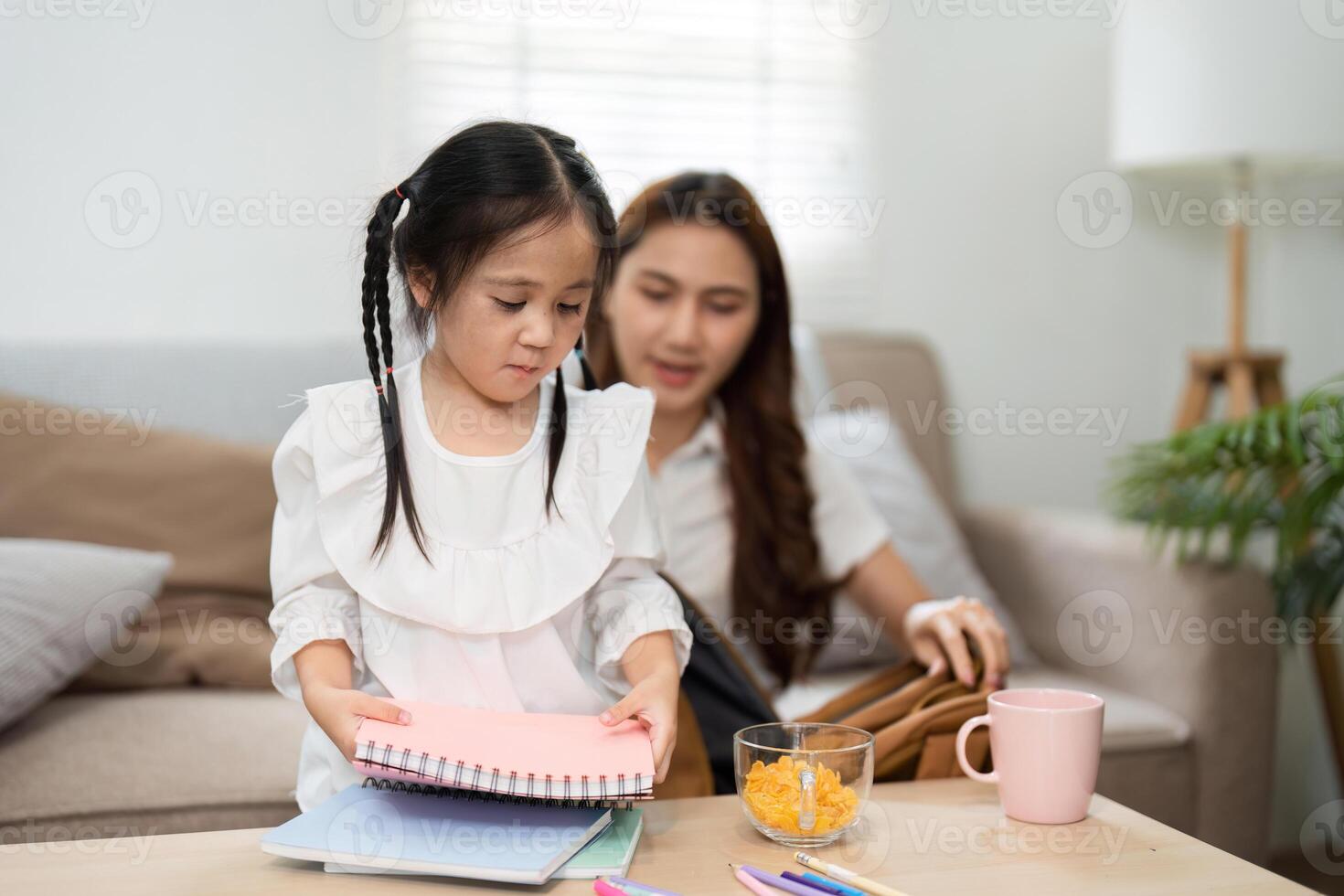 Studying and Exploring Creativity. A child organizes her school supplies, assisted by her mother as they prepare for the school year. photo