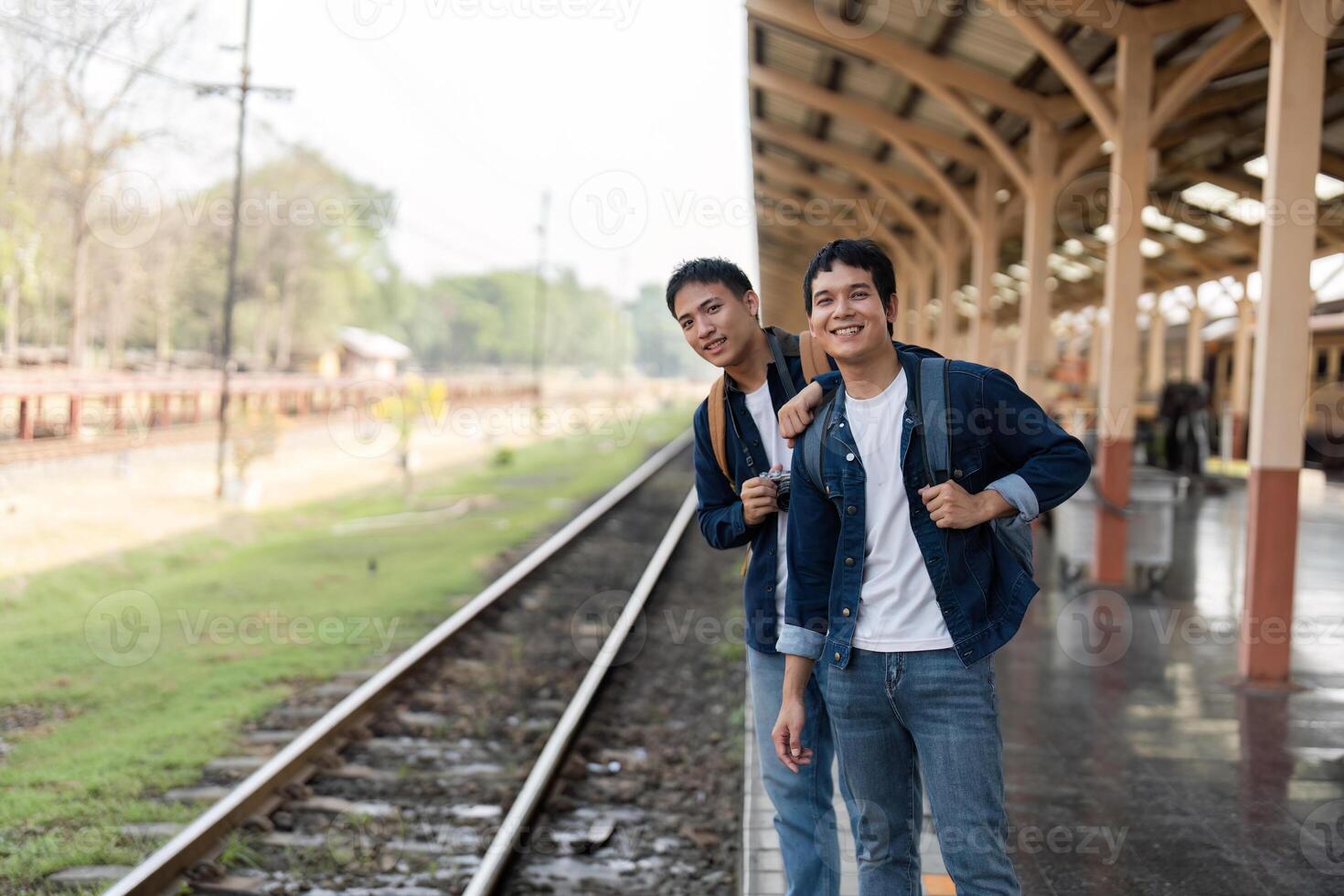 Travel and Exploration. Friends ready for their next journey by the train tracks. photo