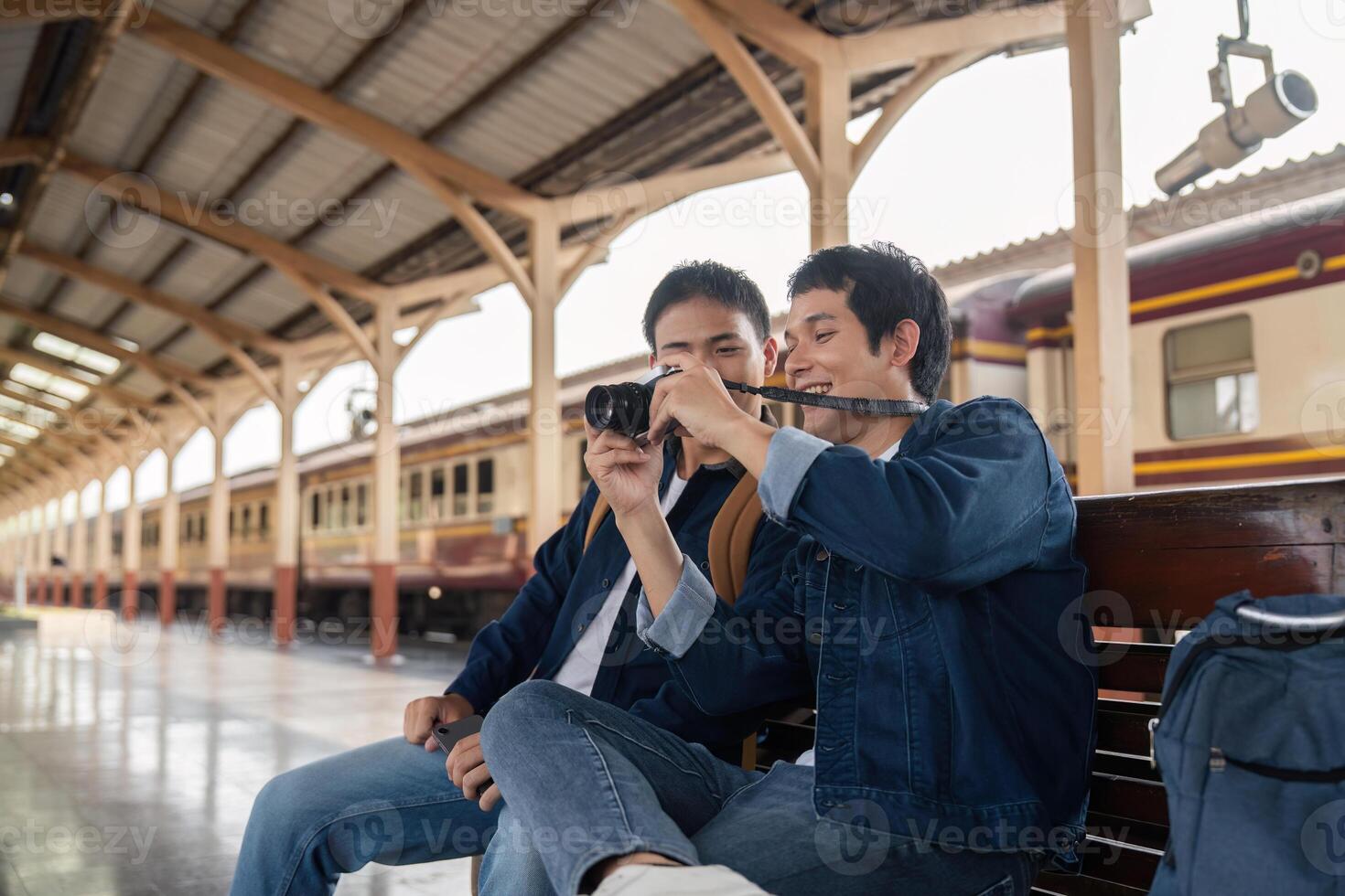 Travel and Friendship. Two friends capturing memories at the train station, sharing excitement for their journey. photo