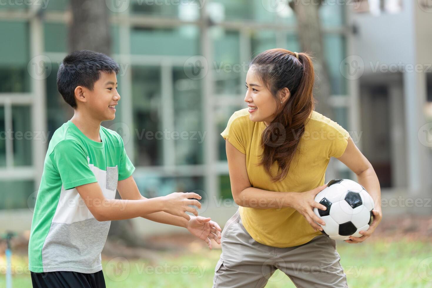 Childhood Joy and Soccer. A boy and girl play soccer in a park, sharing laughter and skill development. photo