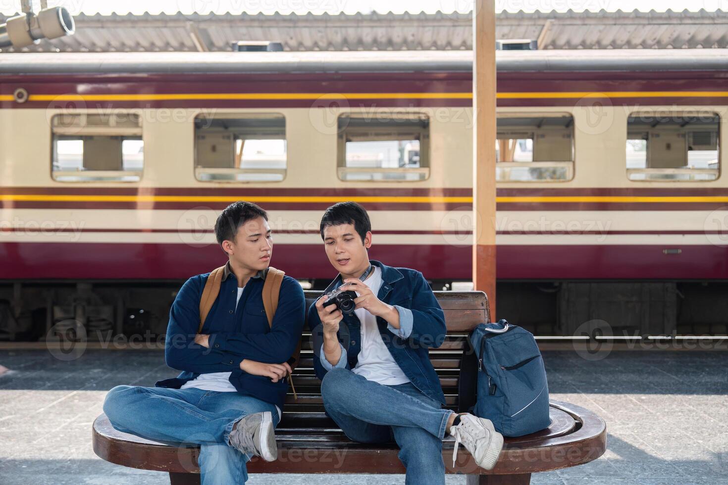 Capturing Memories and Bonding over Travel. Two friends sitting together and reviewing their travel photos. photo