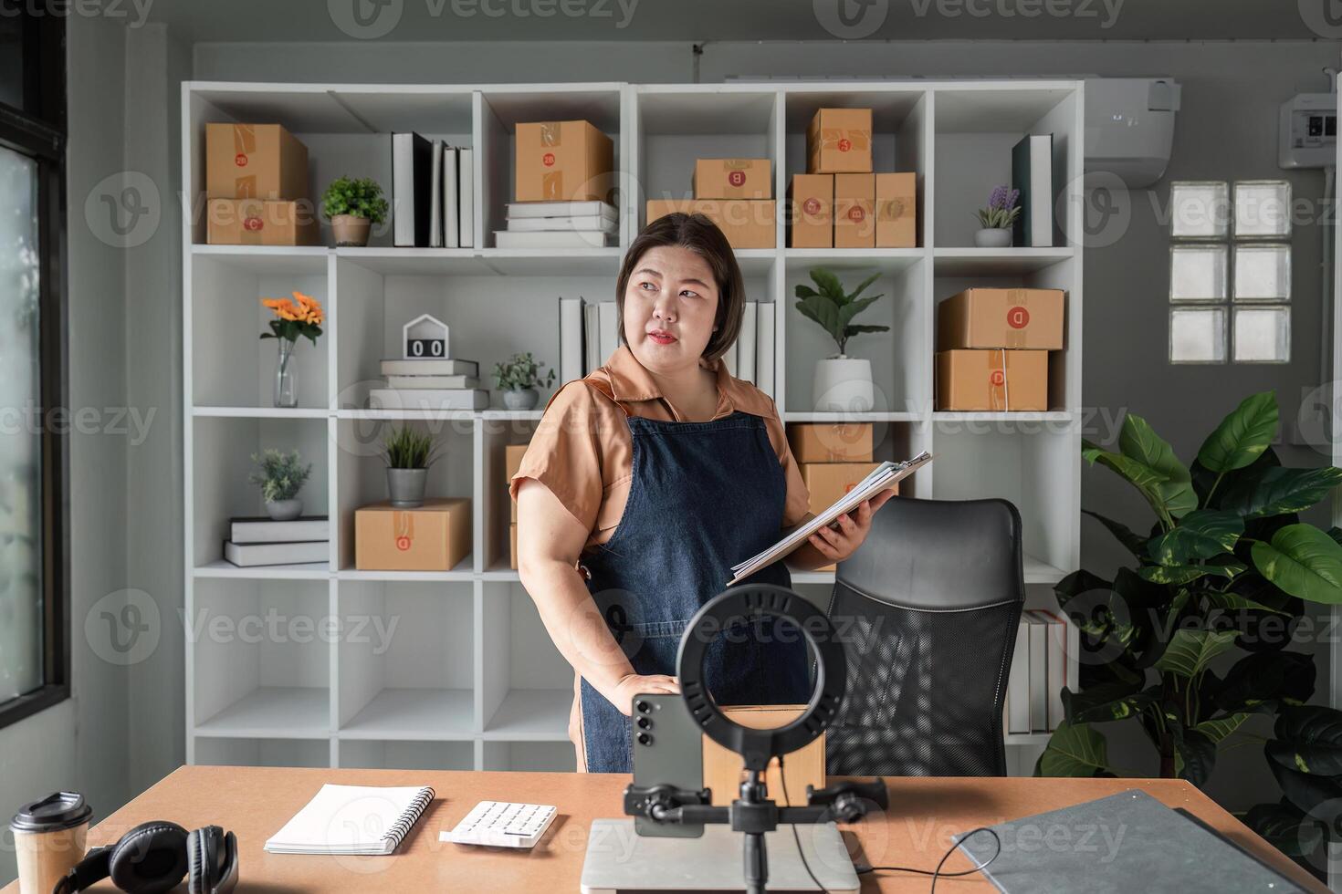 Businesswoman strategizing and organizing her workspace with notes and supplies in a modern office photo