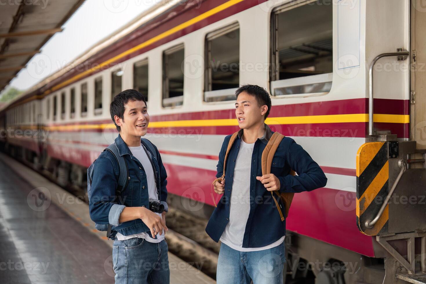 Travel and Exploration. Friends enjoying their time together while interacting near the train before boarding. photo