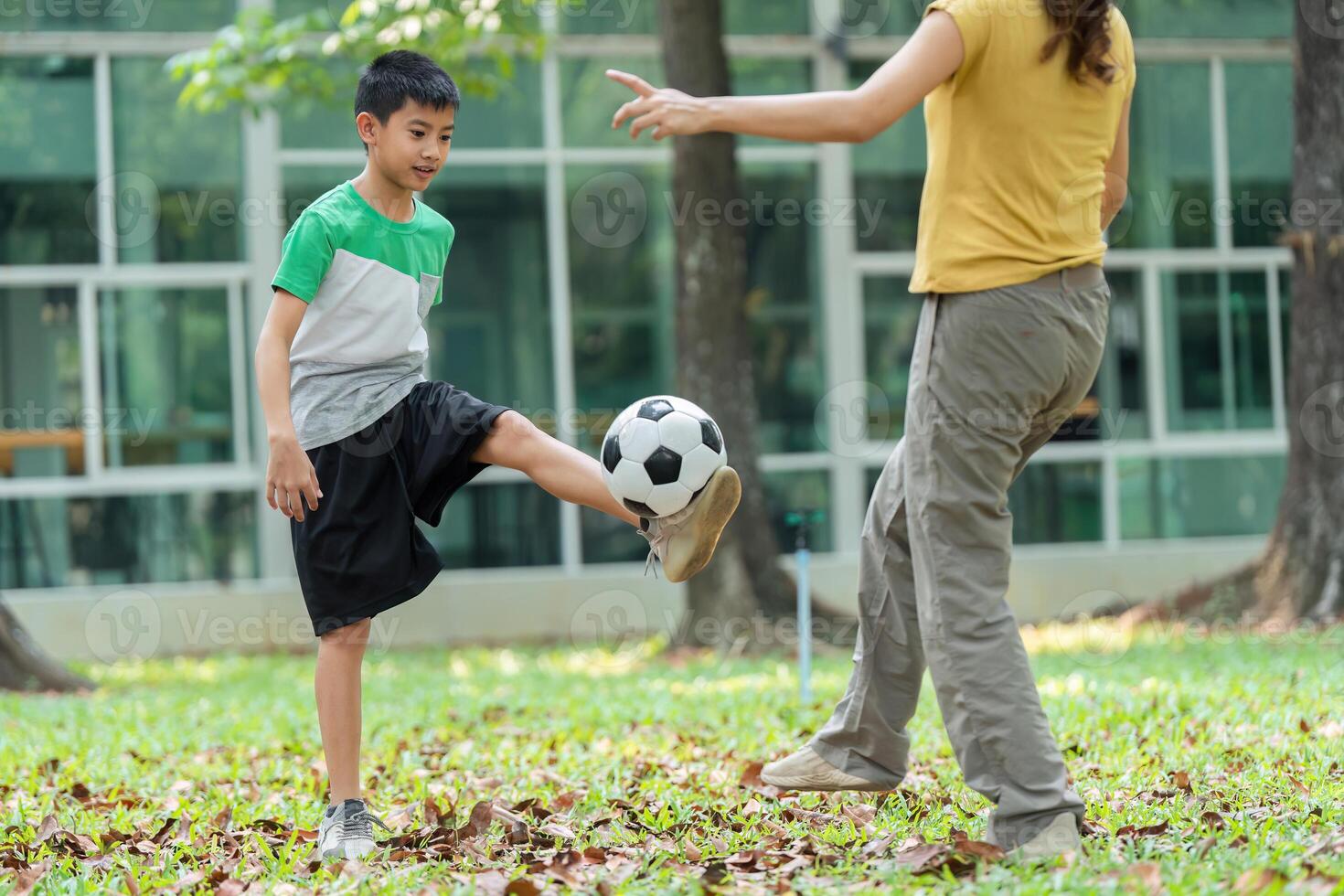 Childhood Exercise and Soccer Practice. A boy skillfully practices soccer with guidance from a girl. photo