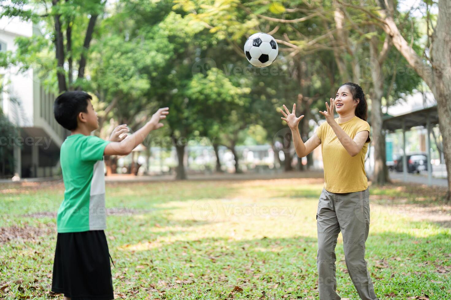 Playful Interaction and Soccer Skills. A boy and girl playing catch with a soccer ball, enhancing their coordination and camaraderie. photo