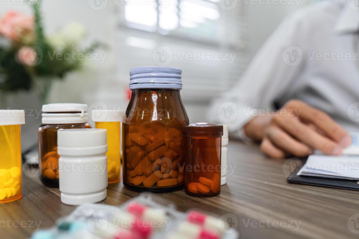 Medication Management and Prescription Review. An array of prescription bottles and medications organized on a table. photo