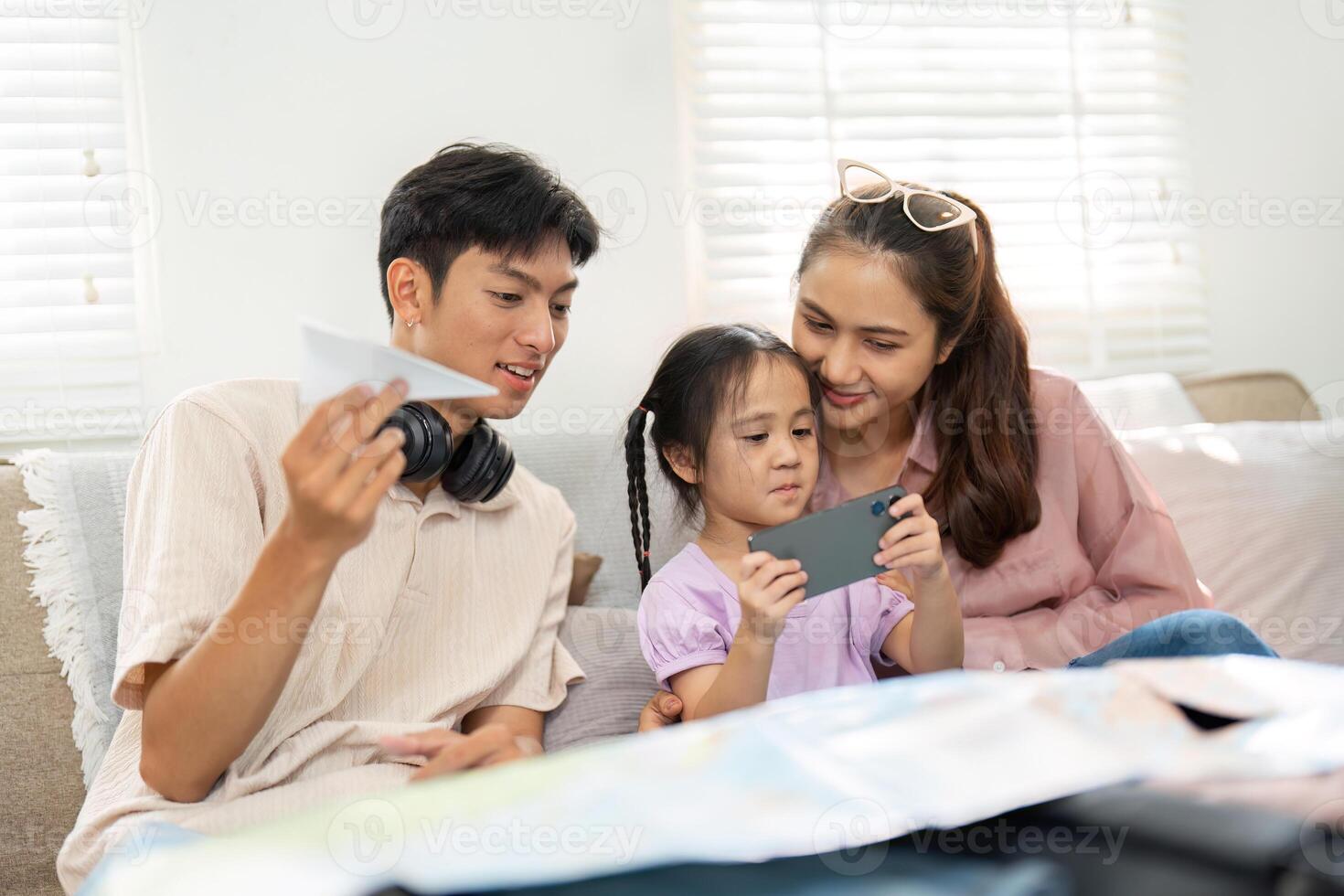 Family Exploration and Learning. Parents guide their child through an exciting adventure with a smartphone, exploring new experiences together. photo