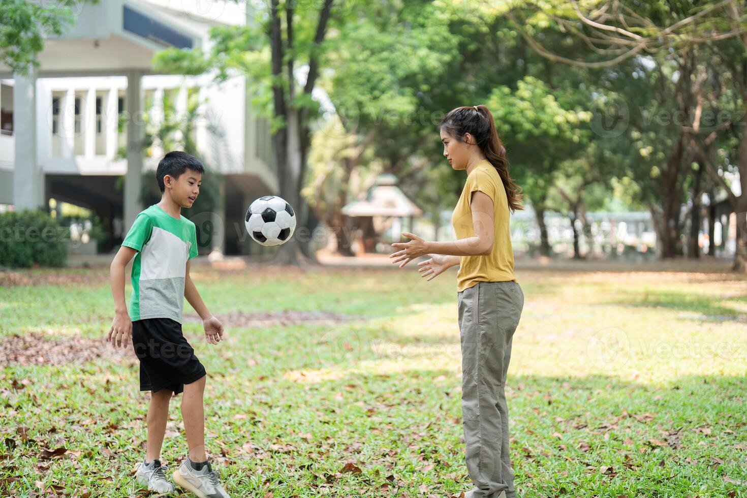 Soccer Fun and Teamwork. Two kids enjoying a playful soccer session in the park, displaying engagement and excitement. photo