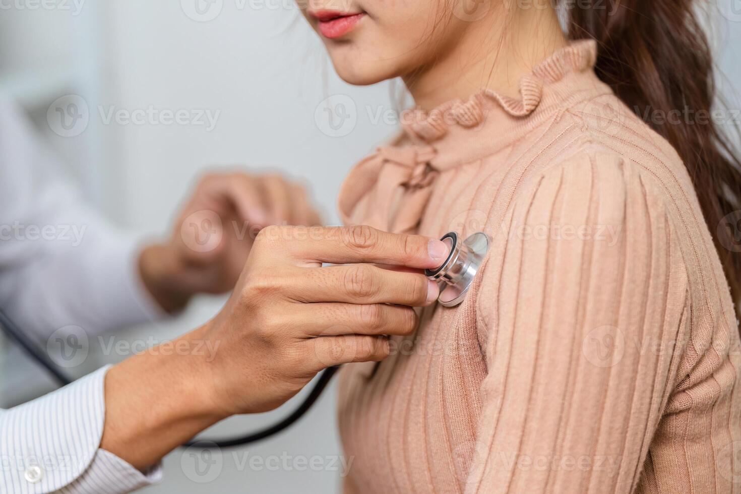 Routine Checkup. A healthcare provider using a stethoscope during a patient examination. photo
