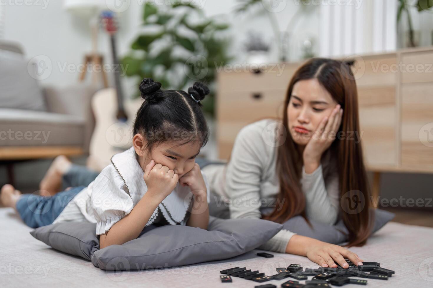Family Bonding and Problem Solving. A mother and daughter share a moment of frustration during a game. photo