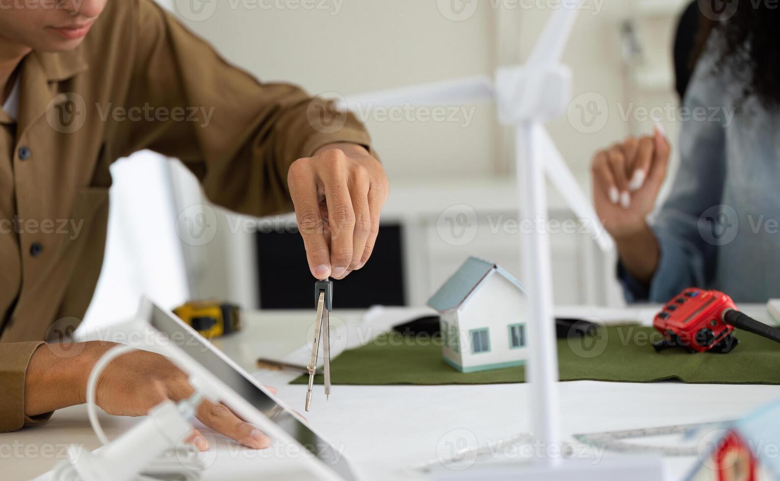 Modeling and Design in Sustainability. A designer using tools to create energy-efficient designs for eco-friendly projects. photo