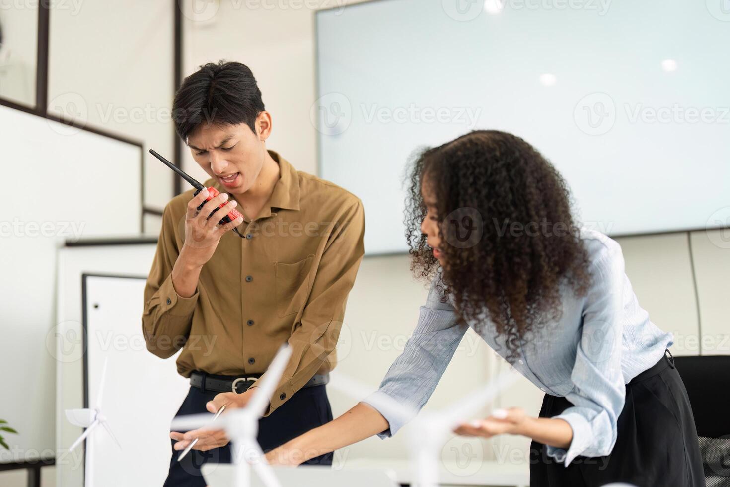 Collaboration and Focused Discussion on Renewables. Professionals brainstorming sustainable strategies in a modern office. photo