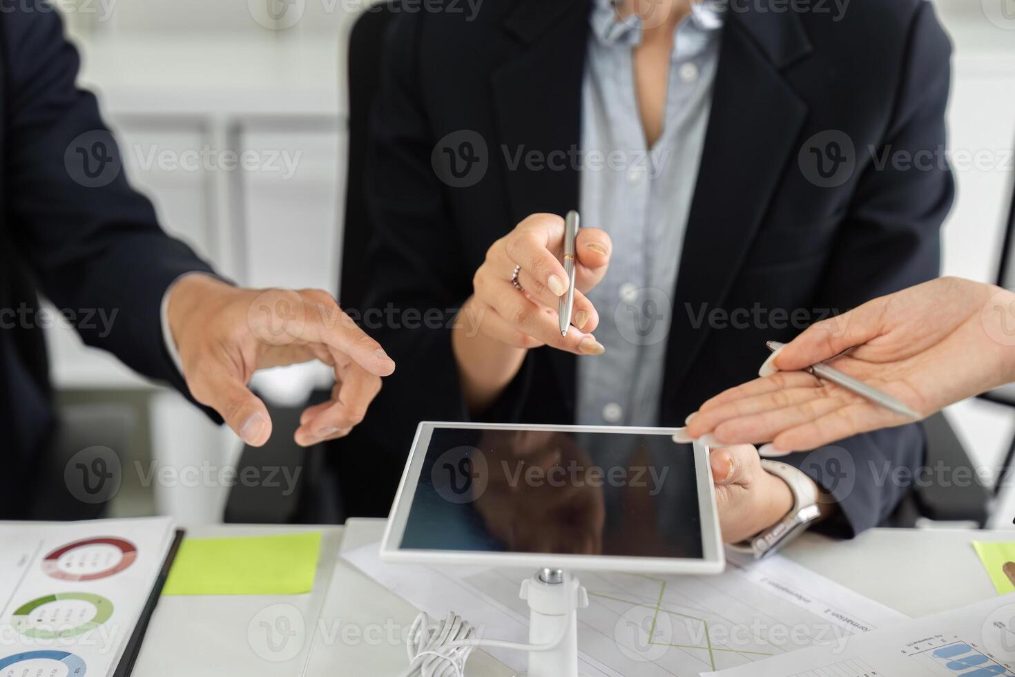 Collaboration and Digital Tools. Team members exchanging ideas using a tablet during a strategy meeting. photo