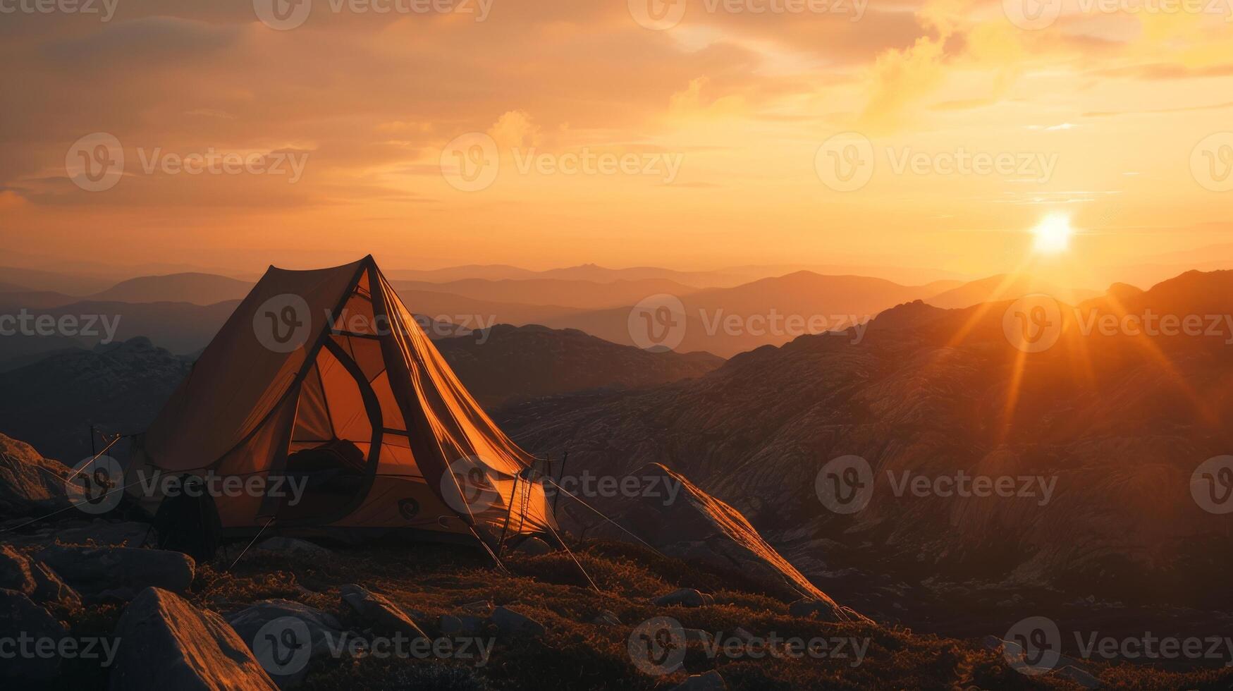 Golden Sunrise Over A Mountainous Landscape With A Lone Tent. photo