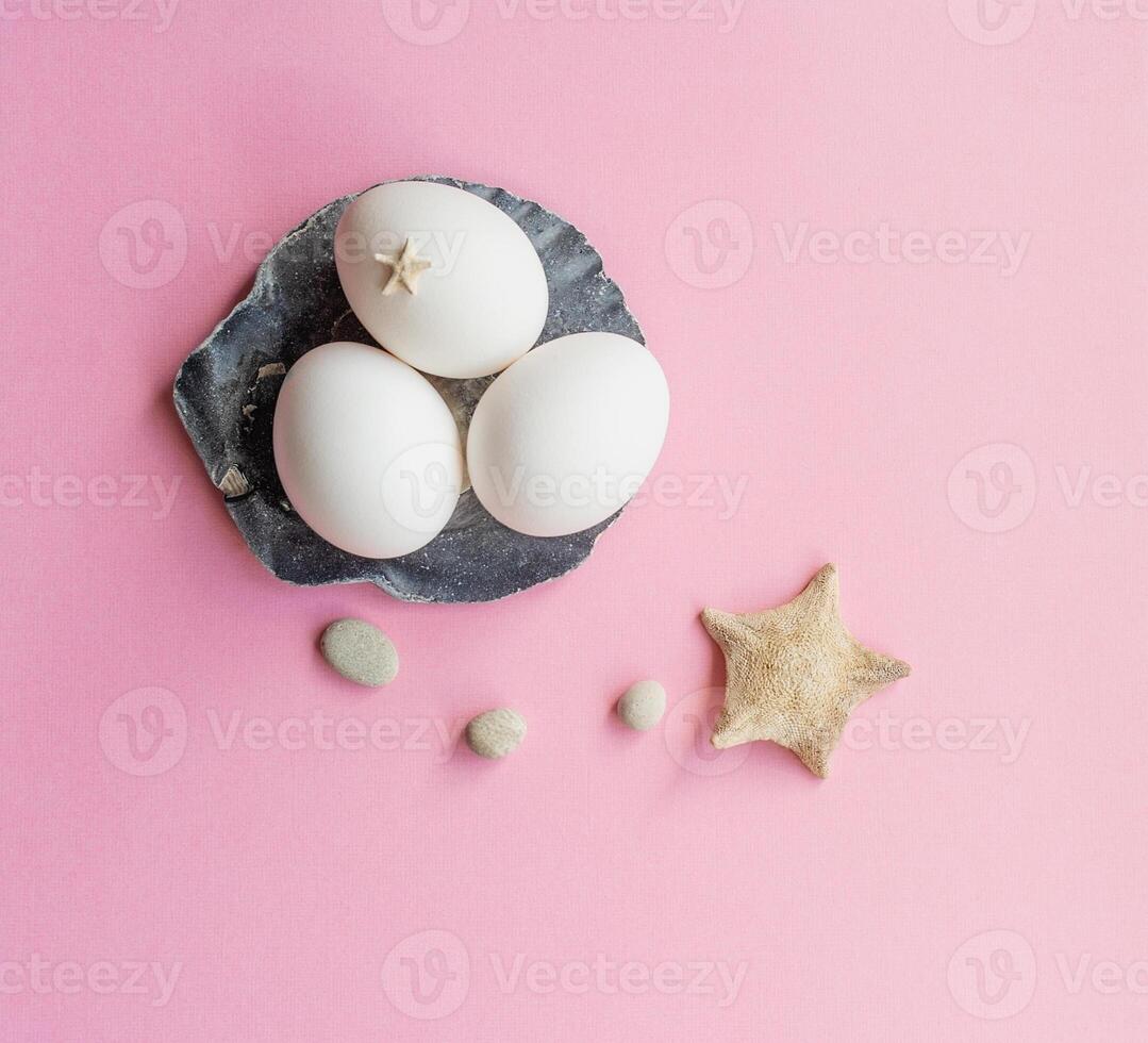 White eggs in an Easter composition with starfish photo