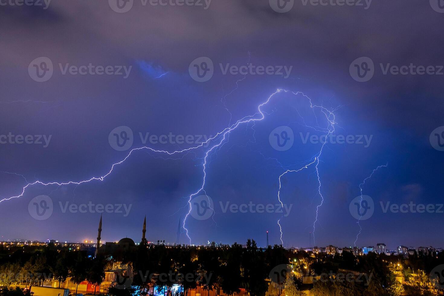 Lightning discharges in the night sky during a thunderstorm. Large thundercloud and lightning discharges. Storm. photo