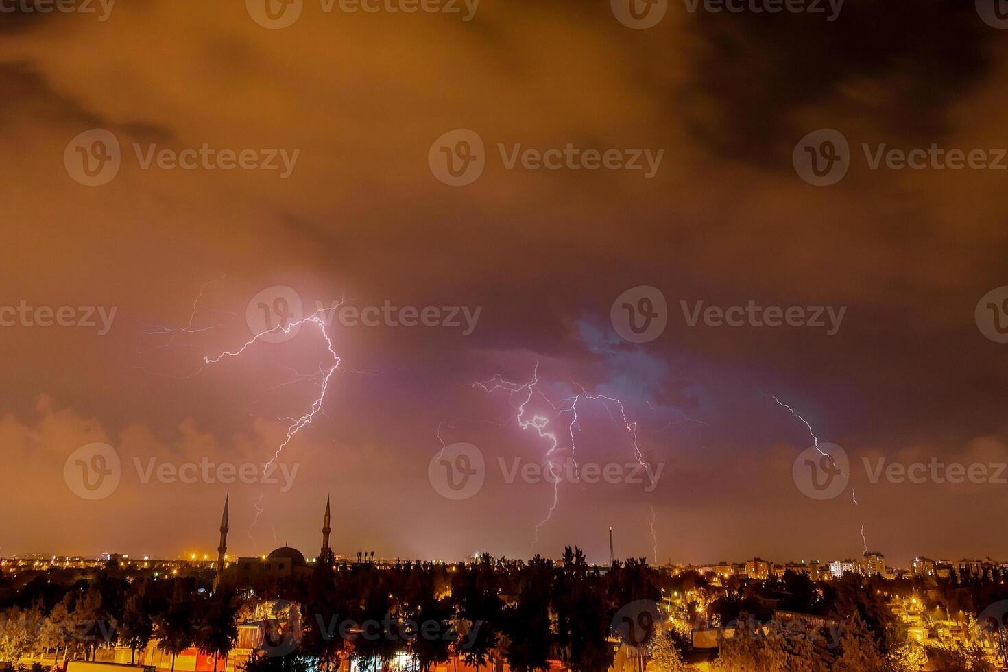 Lightning discharges in the night sky during a thunderstorm. Large thundercloud and lightning discharges. photo