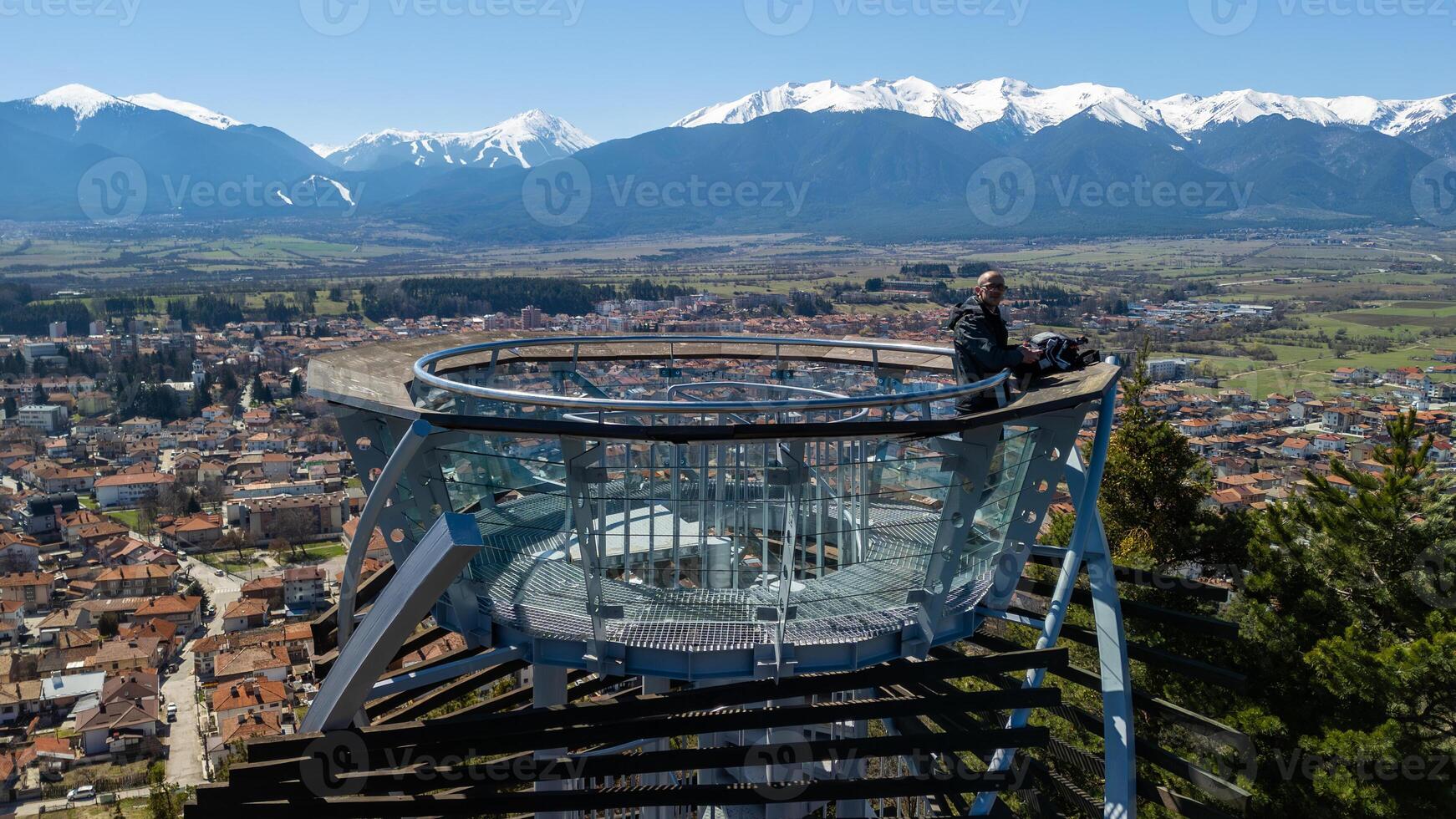 Tourist enjoying panoramic view from Snezhanka Tower observation deck in Pamporovo, Bulgaria photo