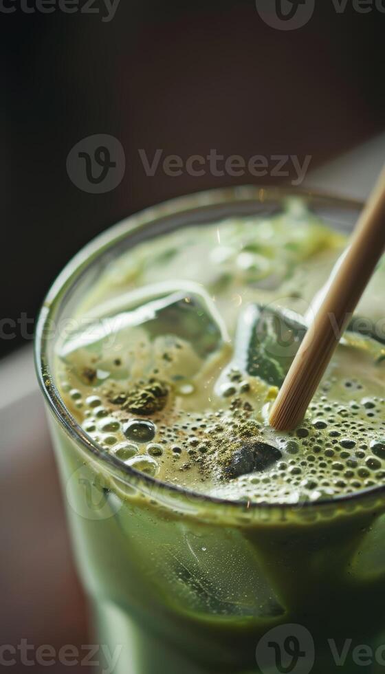 Refreshing Iced Matcha Latte with Bamboo Straw in a Sunlit Setting photo