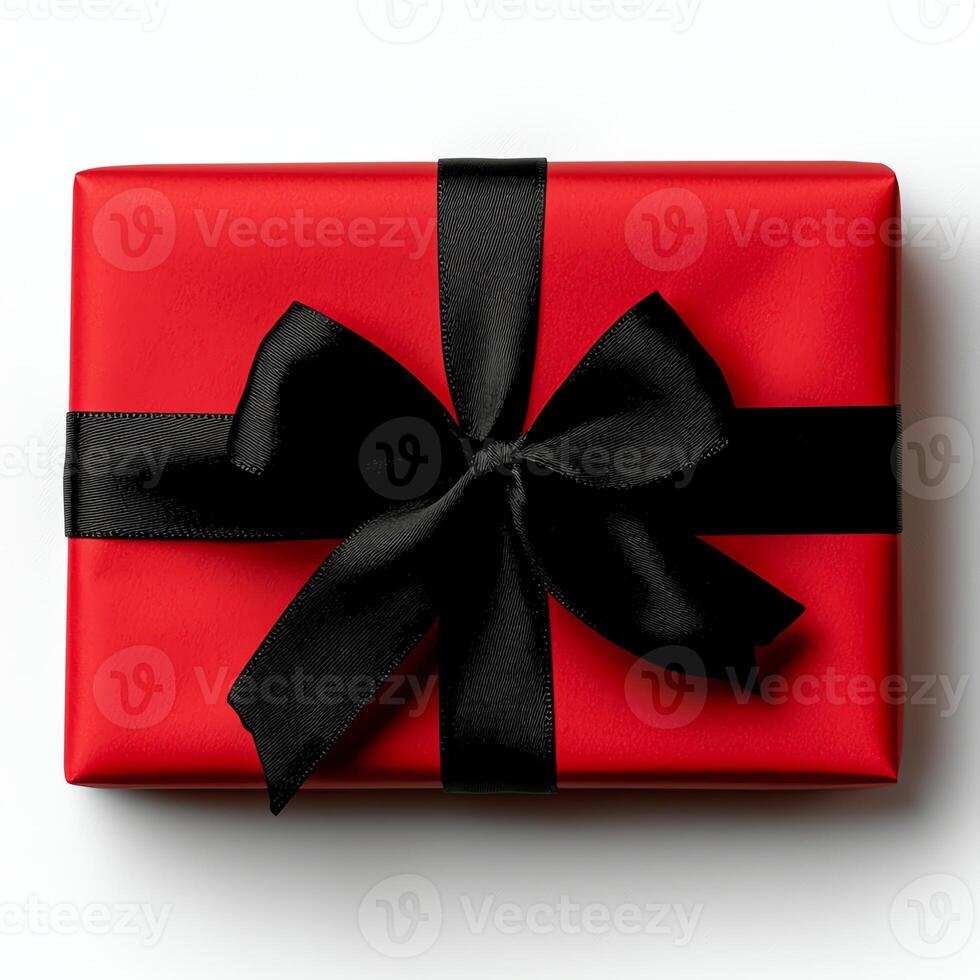 A beautifully wrapped red gift box with a large black ribbon bow on a white isolated background. photo