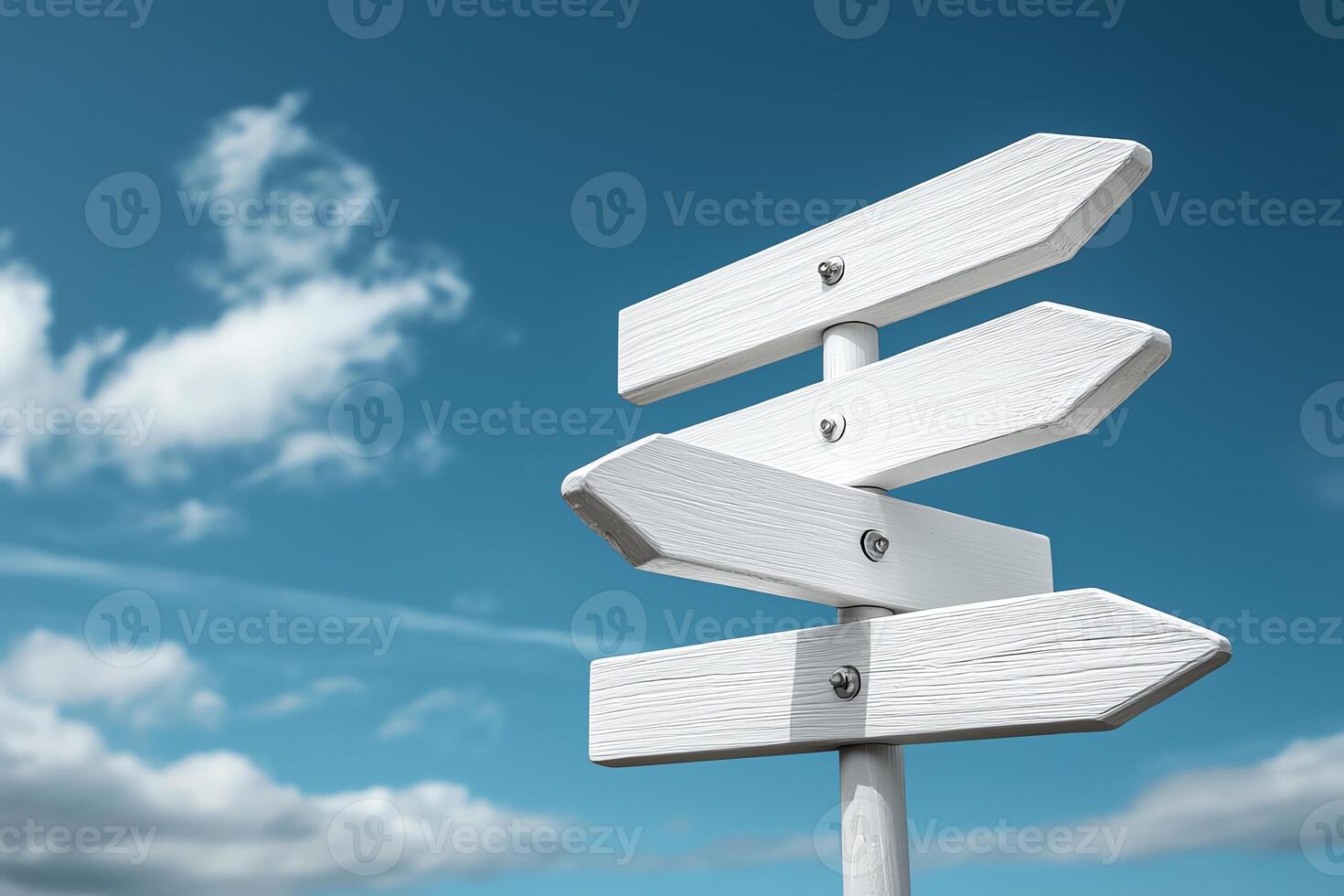 A blank white directional signpost under a clear blue sky, symbolizing choices and directions. Ideal for travel themes, navigation concepts, and decision-making imagery. photo