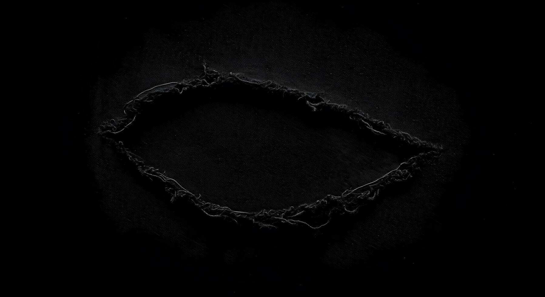 Dark textile with a dramatic rip in the center, showcasing a rugged and distressed texture. Fabric rips texture. photo