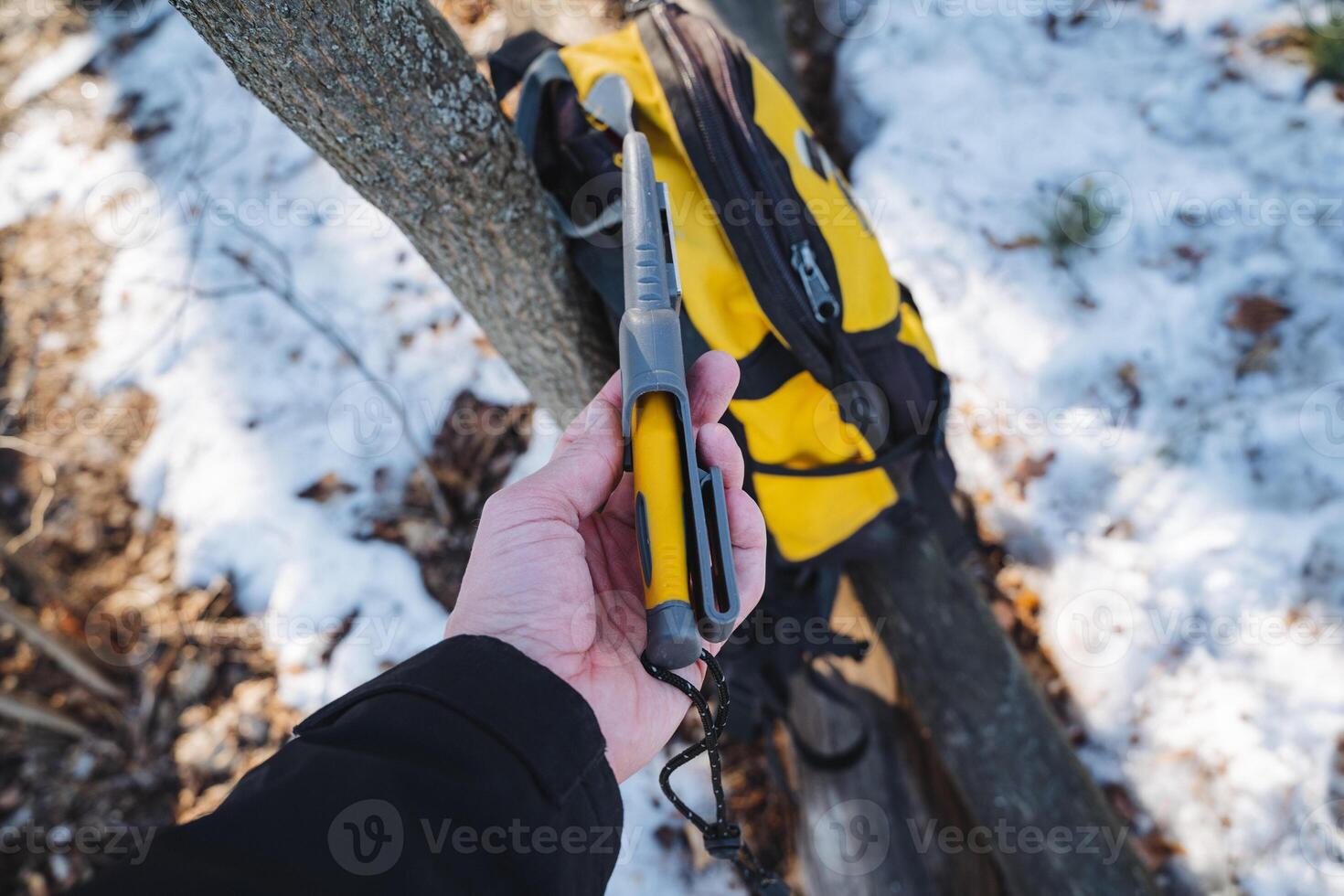 A person is firmly holding a bright yellow and sleek black tool in their hand, showcasing its importance and utility for various activities or tasks they might be involved in photo