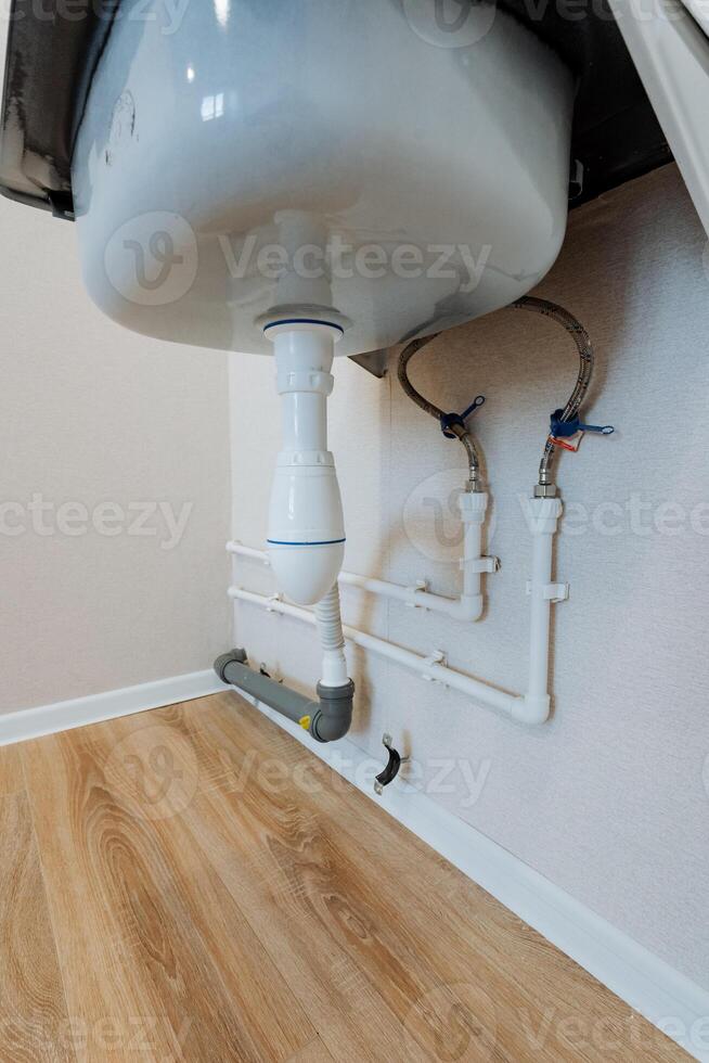 The spacious bathroom features a chic white sink, stylishly and securely mounted on the wall, enhancing its modern aesthetic and practicality, creating an inviting atmosphere photo