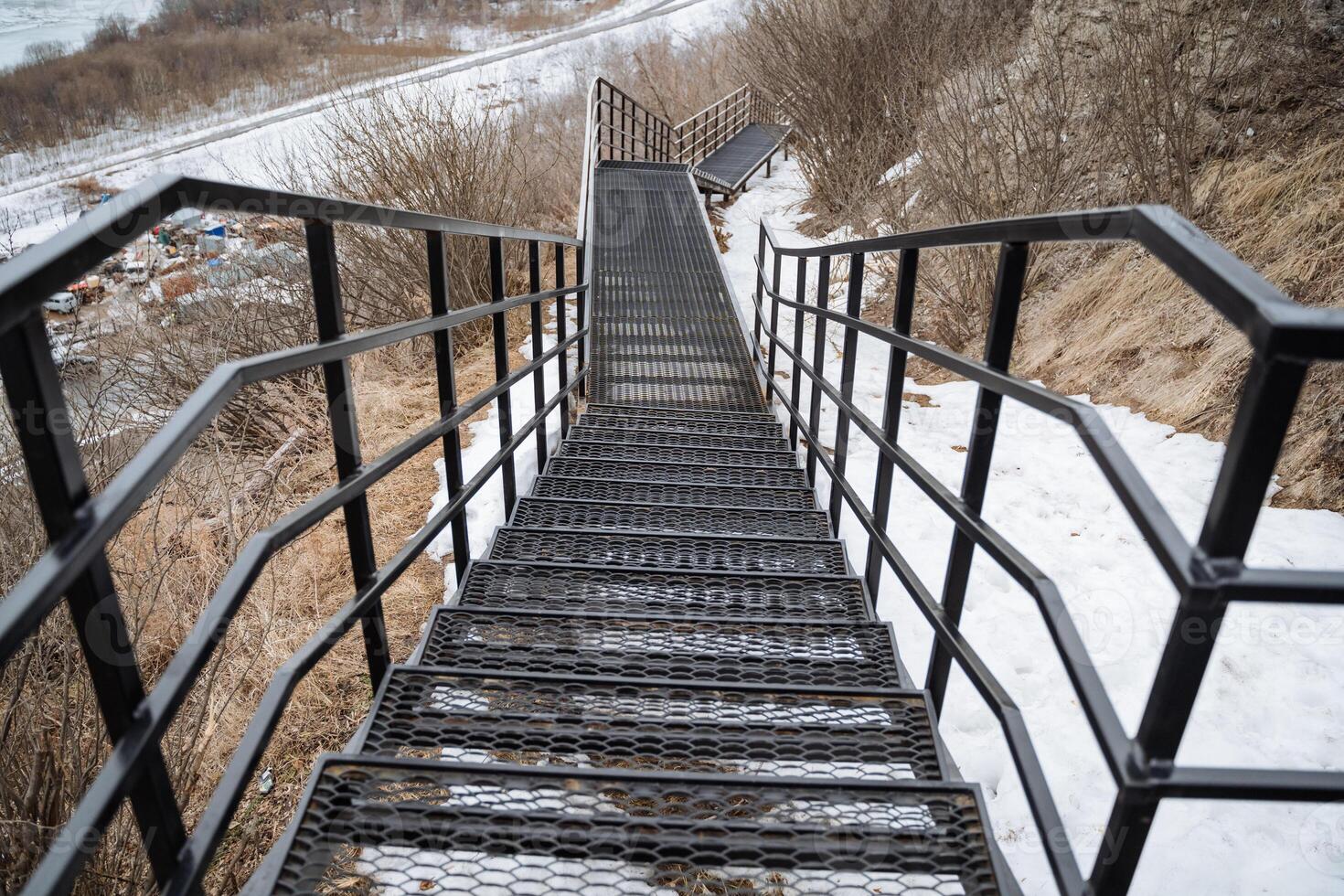 A welldesigned set of stairs, complemented by a sturdy metal railing, ensures a safe and accessible pathway for pedestrians all year round, no matter the season or weather conditions photo