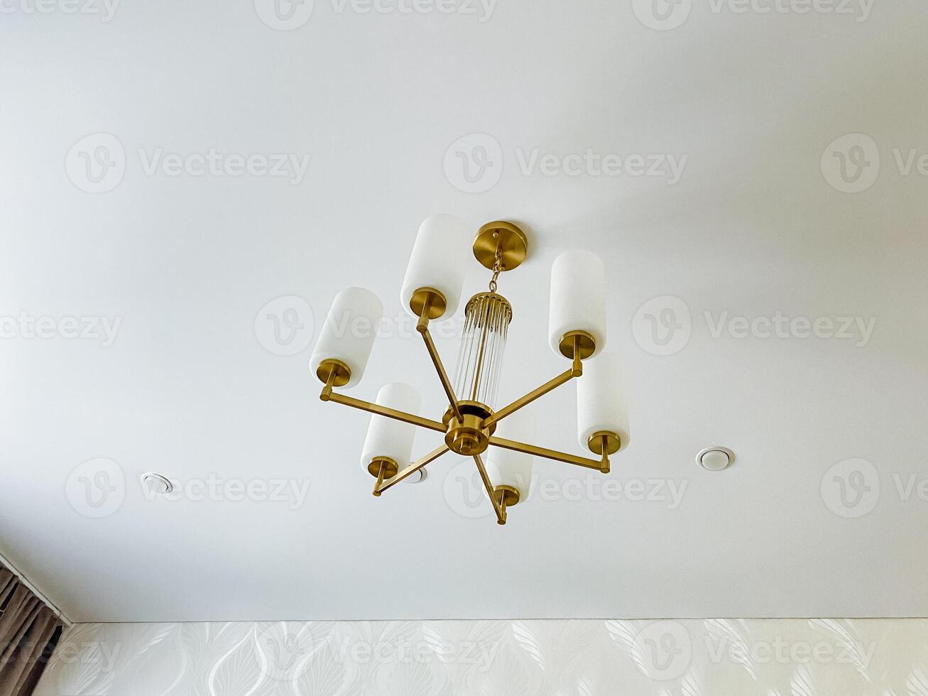 A stunning chandelier beautifully hangs from the ceiling, serving as a captivating focal point that truly enhances the rooms unique charm and elegance, drawing the eye of every observer photo