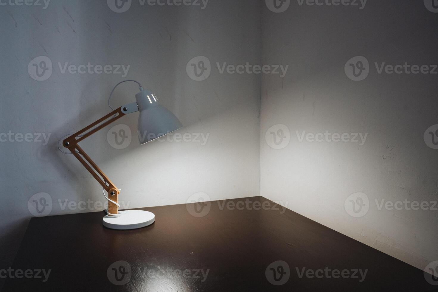 A lamp on a table in a dark room photo