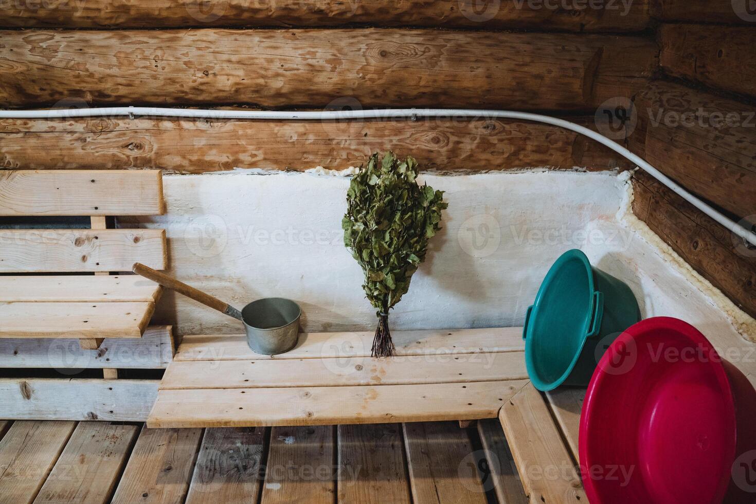 There is a beautifully crafted wooden sauna that features several buckets and a small tree elegantly positioned on the floor, creating a serene natural atmosphere within the space photo