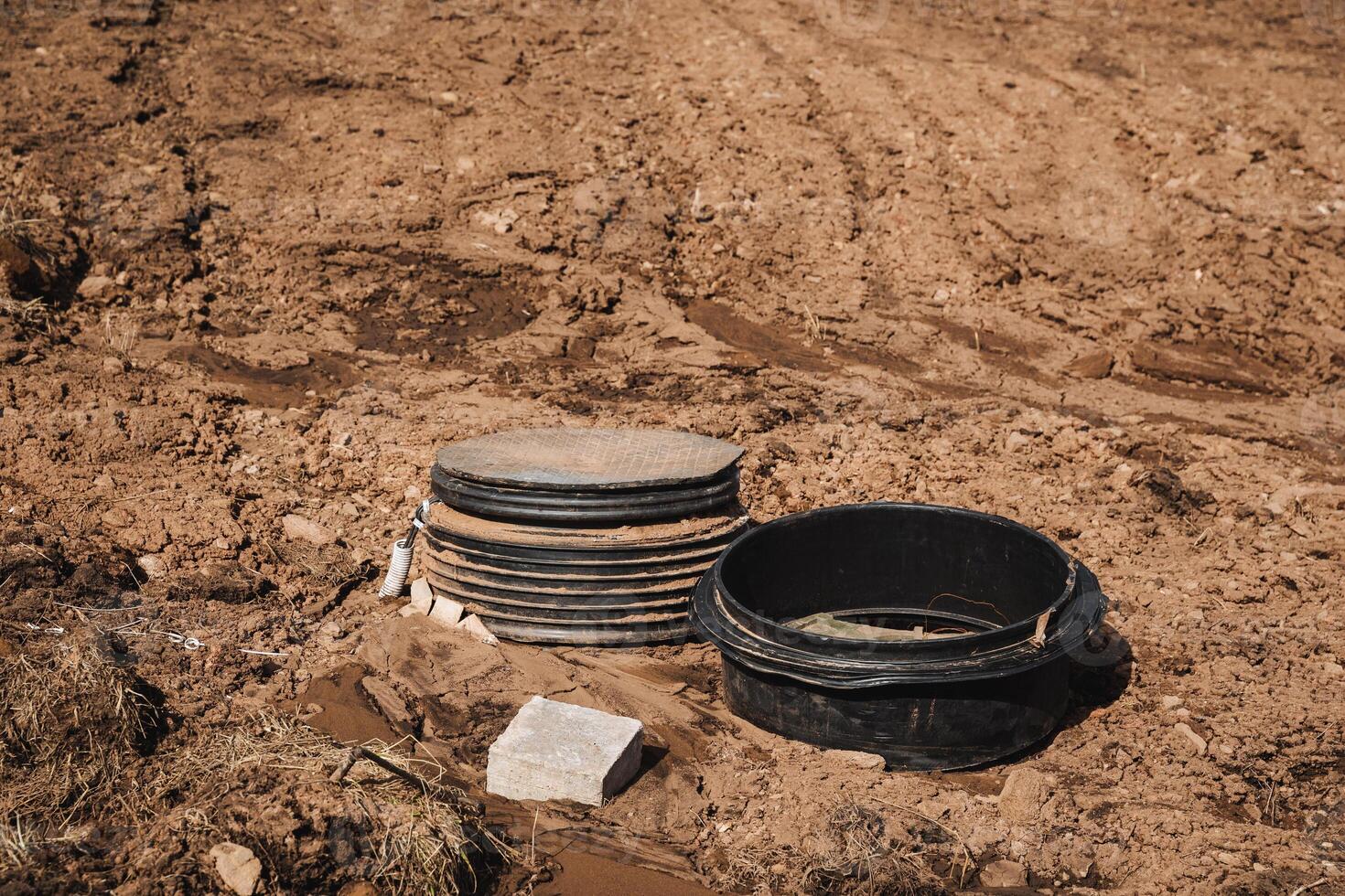 A tall stack of plates balances on an uneven mound of dirt, creating a striking contrast that captures attention and stirs curiosity, urging onlookers to take a closer look photo