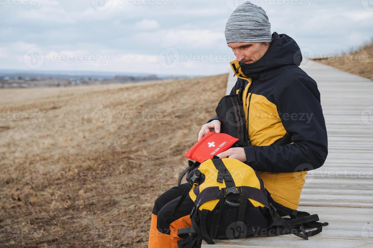 Exploring the Wonders of Nature An Adventurer Pausing to Carefully Organize Their Gear While on the Beautiful Trail Through the Scenic Woods and Majestic Mountains photo