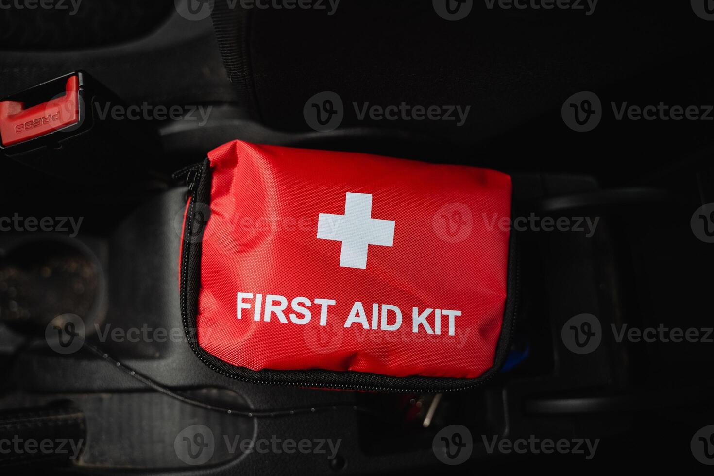 In case of emergencies while driving, there is a red first aid kit prominently displayed, featuring a large white cross, making it easily recognizable and readily accessible for quick help photo