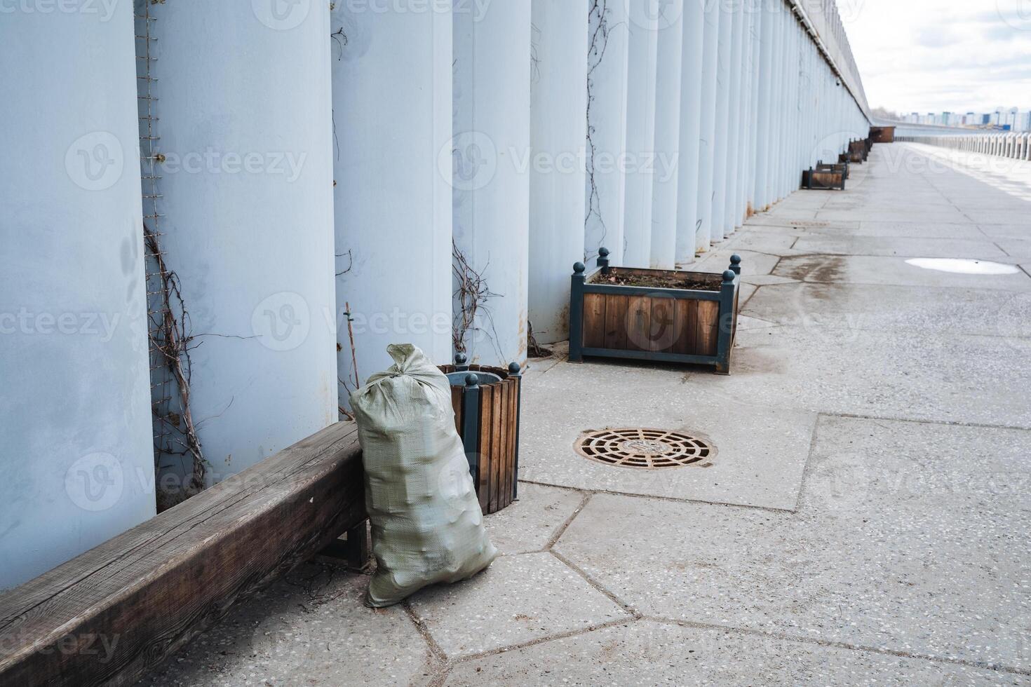 On the sidewalk, a bag is currently resting right next to a bench where people often sit and wait, which adds a delightful bit of character to this lively scene in the urban environment photo