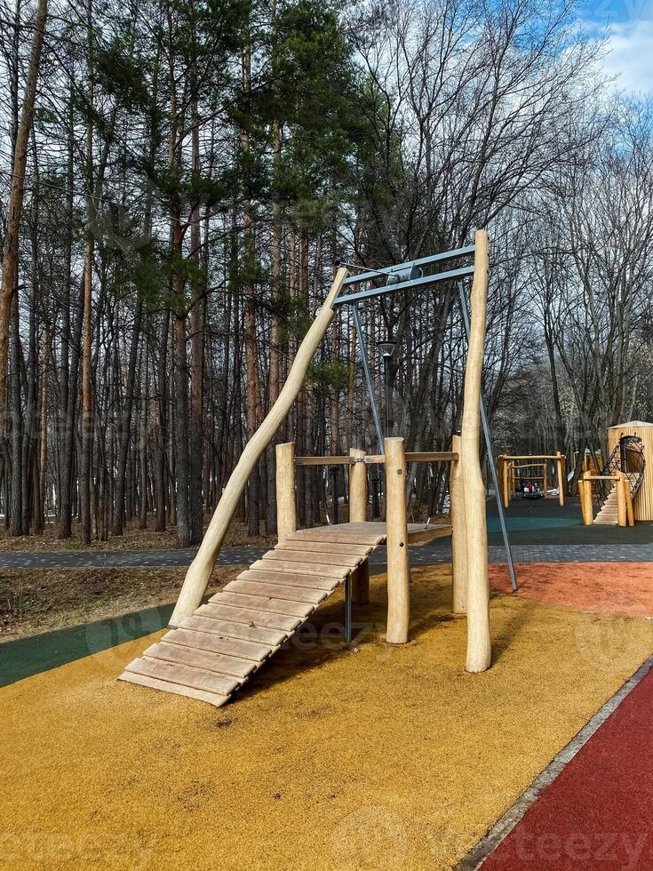 Discover our oneofakind playground design, which includes a unique climbing structure and an exciting swing set, all set beautifully within a natural outdoor environment photo